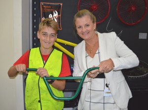 Year 8 student Lleyton Browne, 13, shows Redland City Mayor Karen Williams his newly painted bike handle.